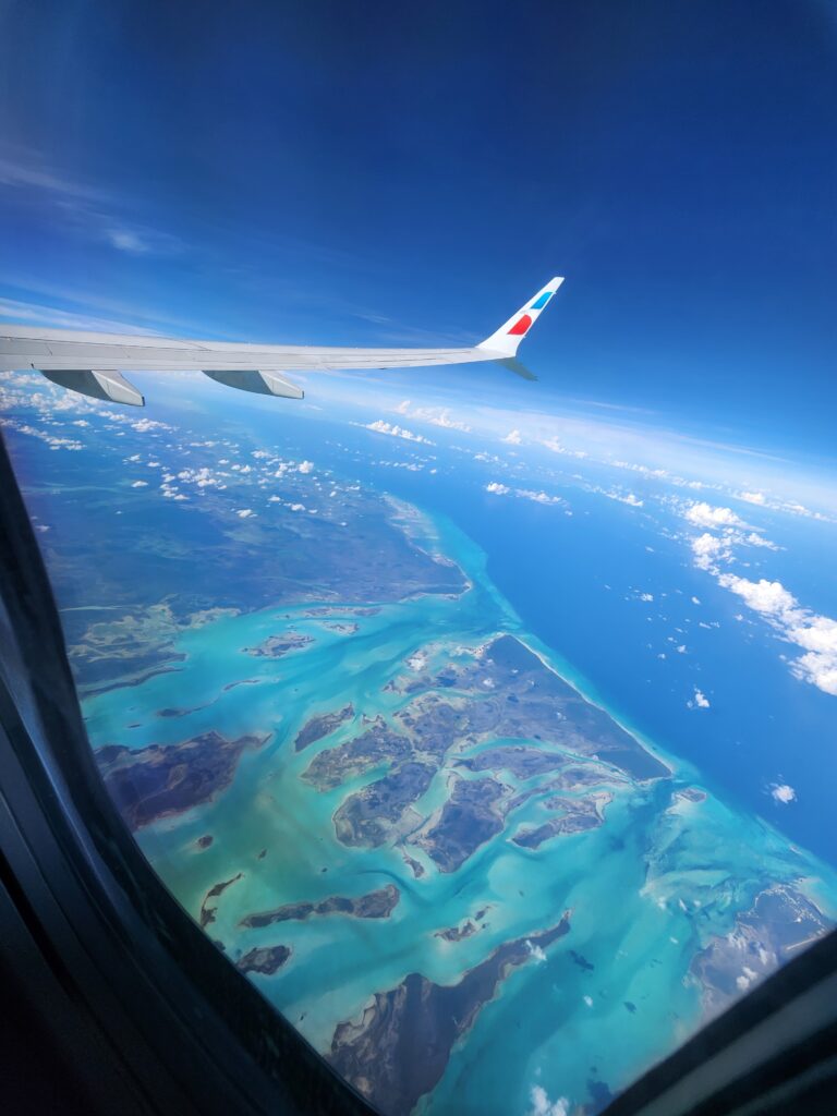 Aeriel photo of light blue water in the Bahamas. Wander&Prosper.